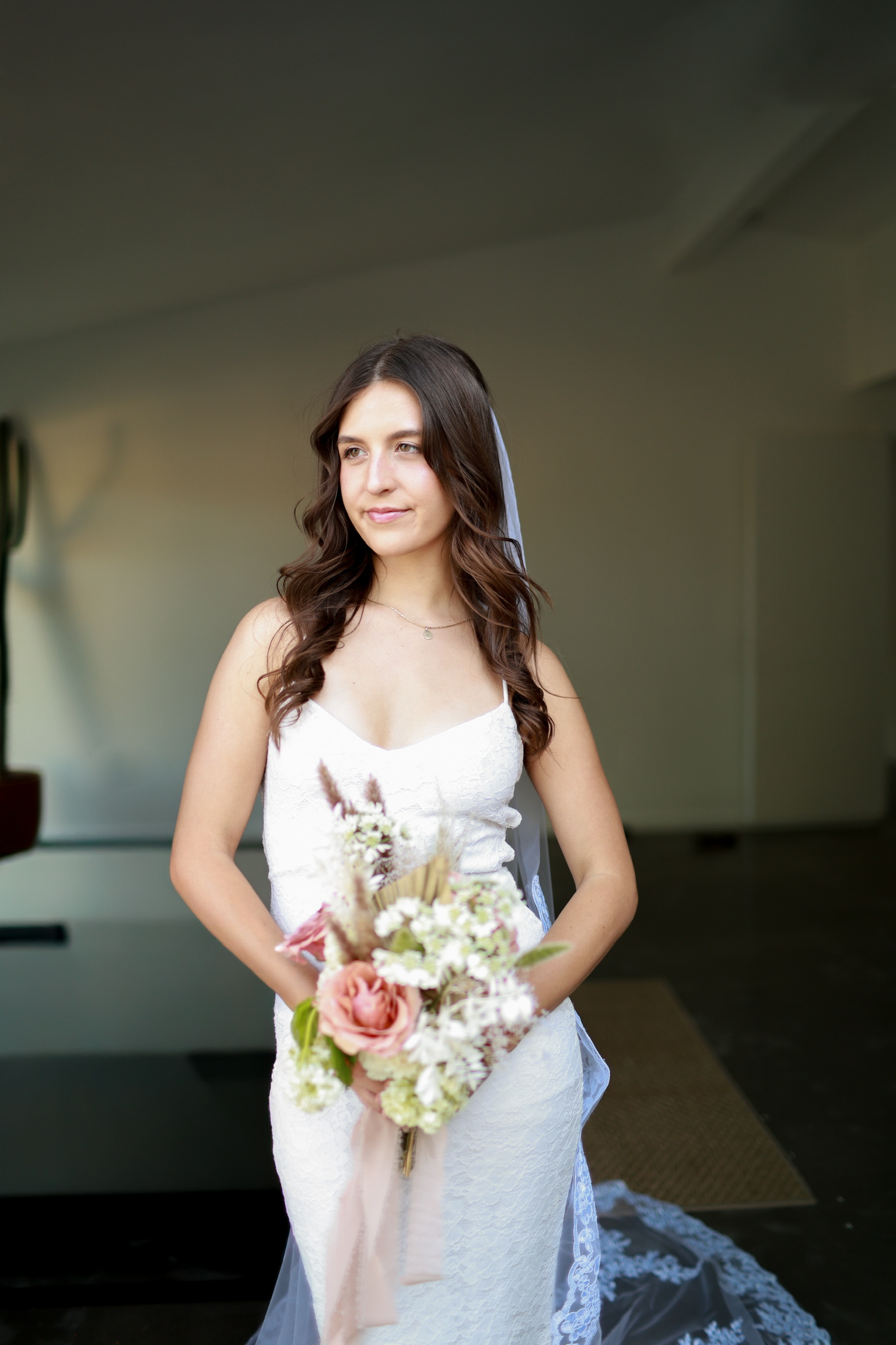 Bride holding bouquet indoors
