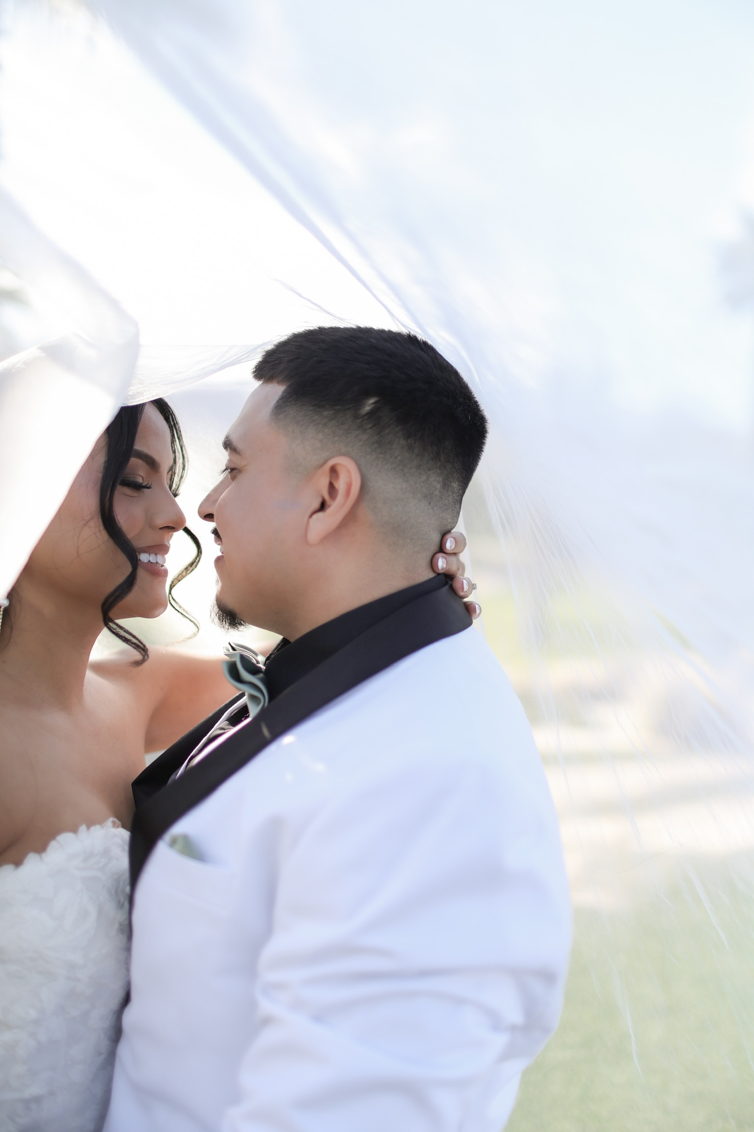 Close wedding portrait beneath a veil